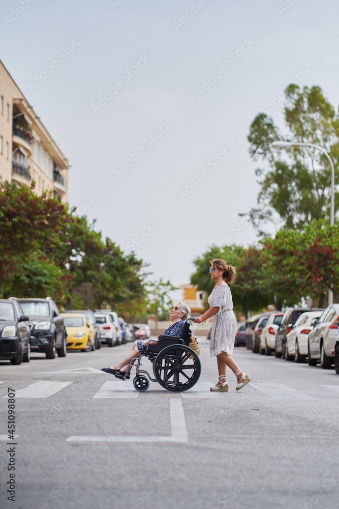 Woman and her 90 year old mother crossing the street
