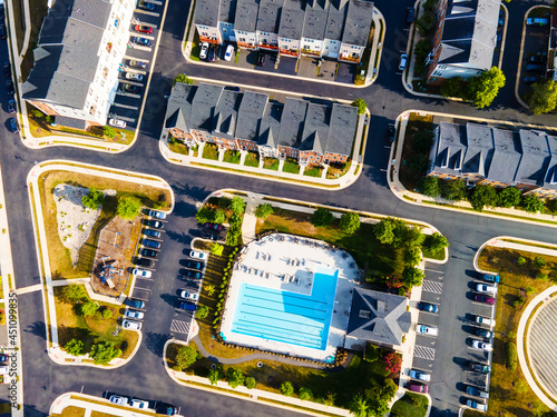 Aerial view of a residential area with a swimming pool from a drone photo