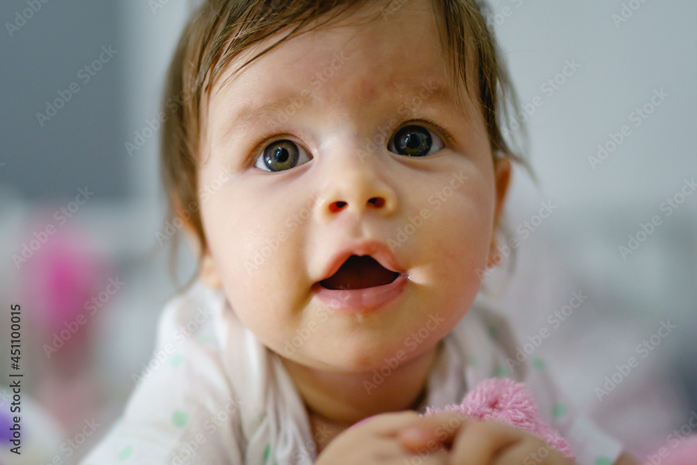 Close up portrait of small caucasian baby girl four months old front view Close up portrait of small caucasian baby girl four months old front view