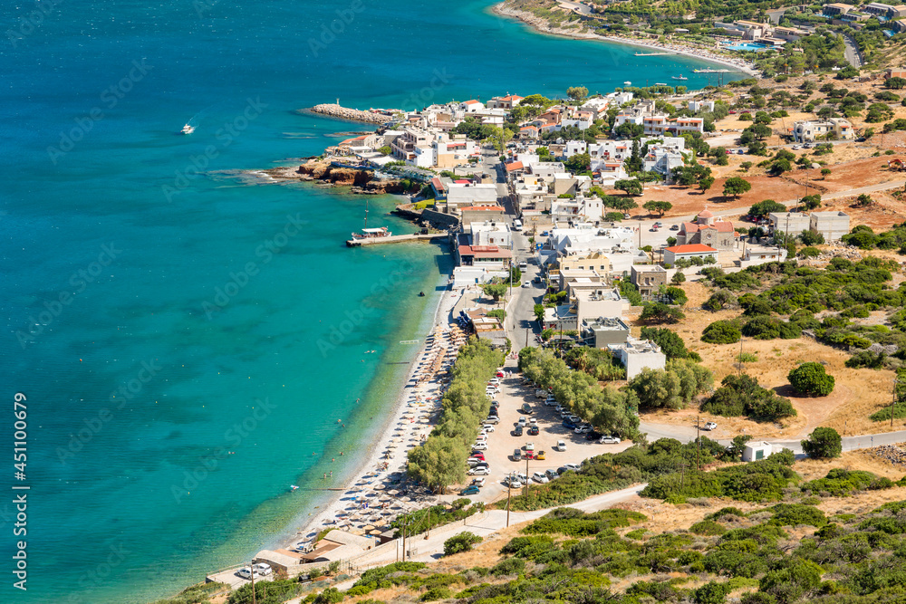 Small Greek coastal village with beach and clear blue sea (Plaka, Elounda, Crete)