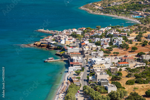Small Greek coastal village with beach and clear blue sea (Plaka, Elounda, Crete)