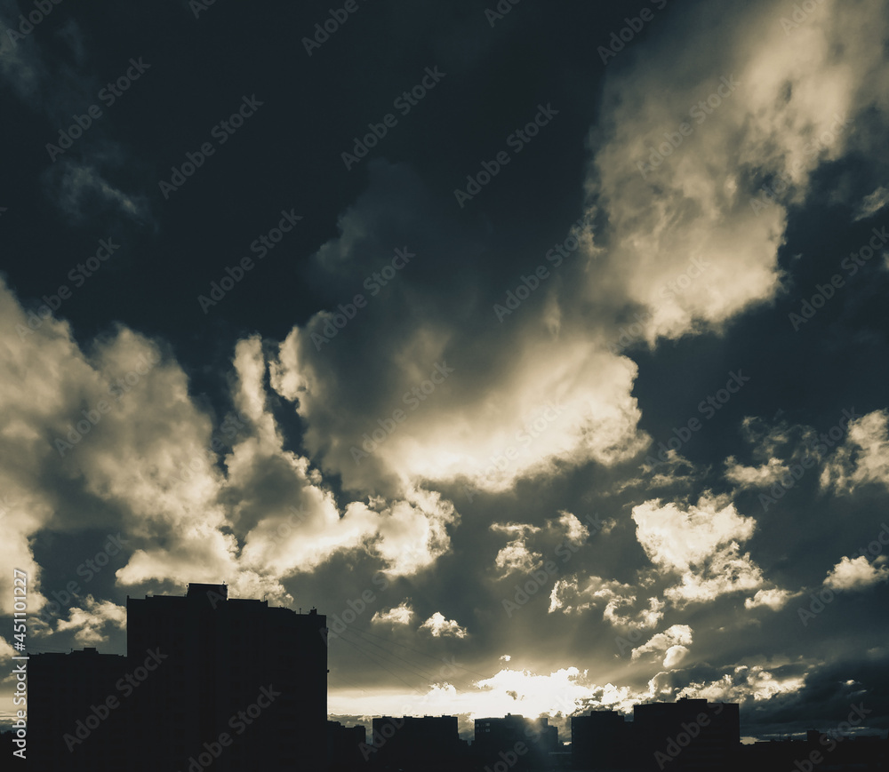 City skyline with dramatic cloudy sky at sunset