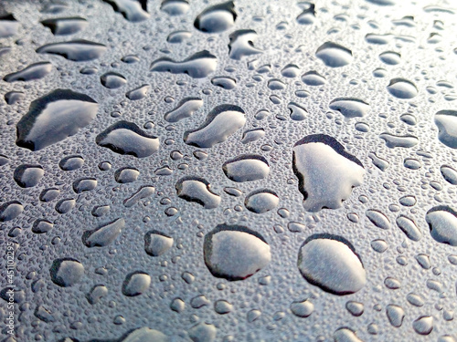 water droplets on the roof of a black car abstract background