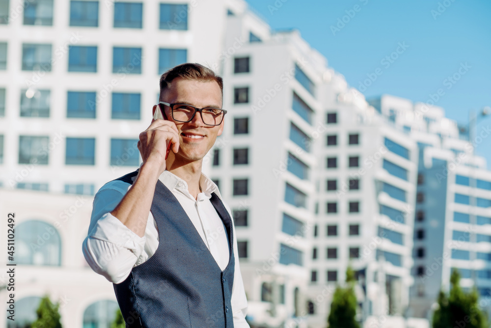 confident young man with a smartphone looking at the camera. confident young man with a smartphone looking at the camera.