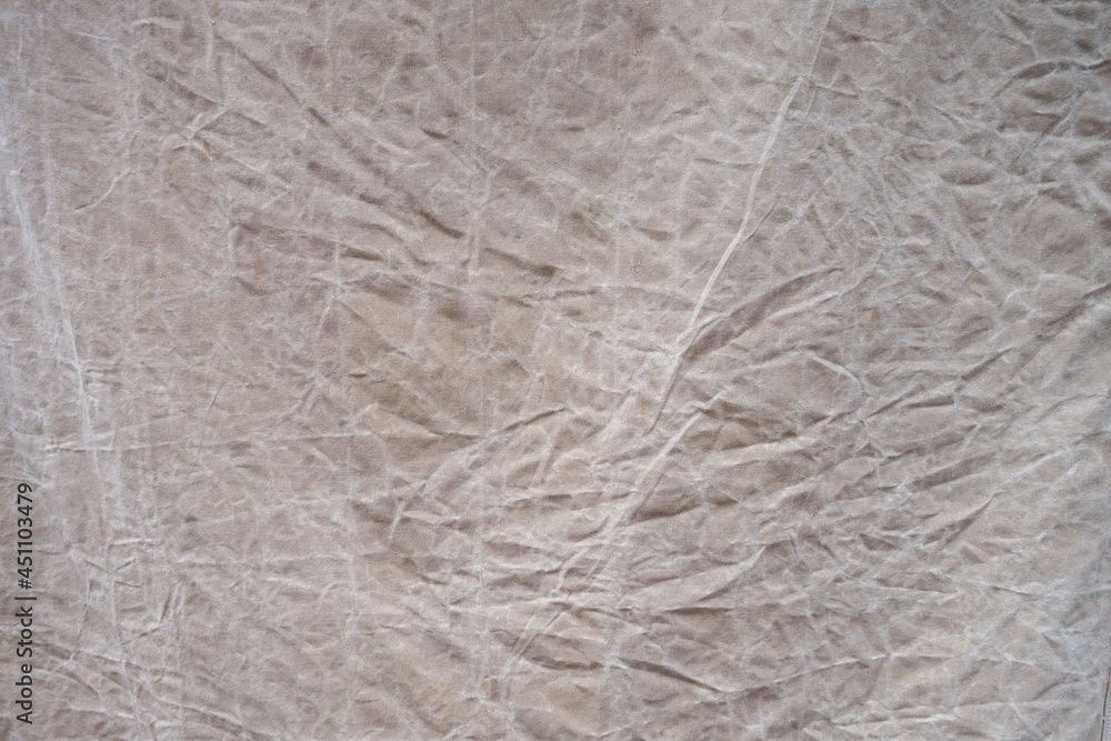 Fototapeta premium distresed crinkled tan cloth covering with folded marks