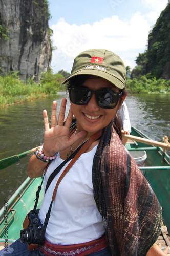 Travelers thai women people travel visit shooting take photo on boat tour trip Tam Coc Bich Dong or Halong Bay on Land and Ngo Dong river and cave of limestone mountains at Ninh Binh in Hanoi, Vietnam