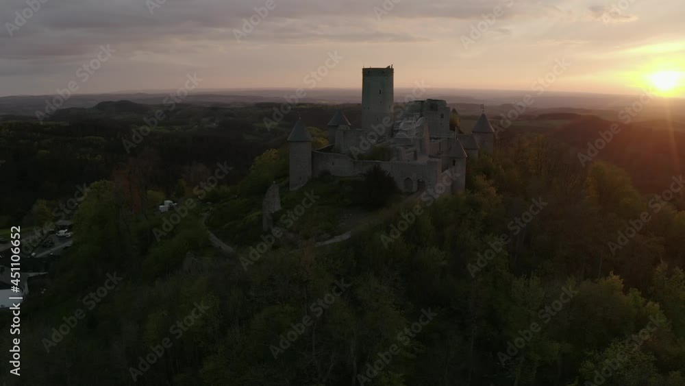 Aerial view Moving right shot, Scenic view of Castlec Nürburg on the top of Hill in Eifel in Germany, Sun rises in the background. Aerial view Moving right shot, Scenic view of Castlec Nürburg on the top of Hill in Eifel in Germany, Sun rises in the background.