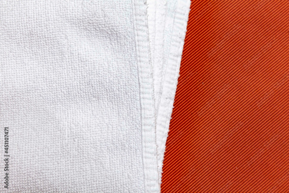 Clean white towels folded on brown sofa Clean white towels folded on brown sofa