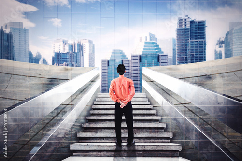 Businessman looking at modern city on stairs