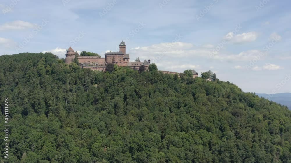 Aerial shot uphill showing a renovated medieval castle in the Alsace region of France Aerial shot uphill showing a renovated medieval castle in the Alsace region of France
