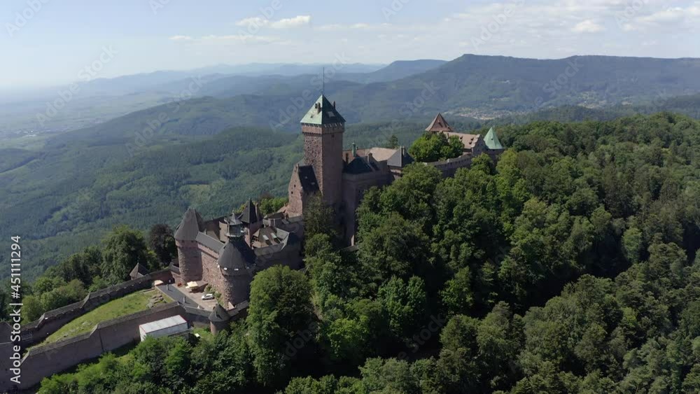 Circulating aerial shot of a tower of a renovated medieval castle in the Alsace region of France Circulating aerial shot of a tower of a renovated medieval castle in the Alsace region of France