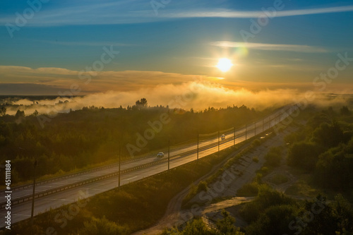 the rising sun peeps over the horizon and illuminates the beautiful summer landscape