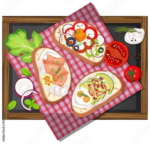 Top view of different bruschettas on wooden tray isolated
