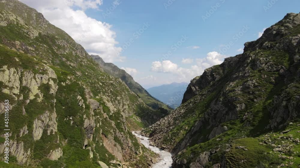 wide angle drone video of the beautiful mountains in northern Italy with a giant waterfall and river. near the dolomites in South Tyrol. wide angle drone video of the beautiful mountains in northern Italy with a giant waterfall and river. near the dolomites in South Tyrol.