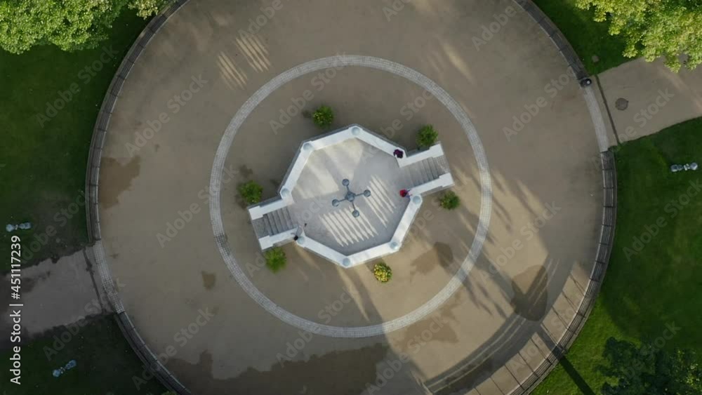 People's Park, Dun Laoghaire, Dublin, Ireland, August 2021. Bird's-eye view of bandstand as drone gradually rotates while ascending revealing wider view of park. People's Park, Dun Laoghaire, Dublin, Ireland, August 2021. Bird's-eye view of bandstand as drone gradually rotates while ascending revealing wider view of park.