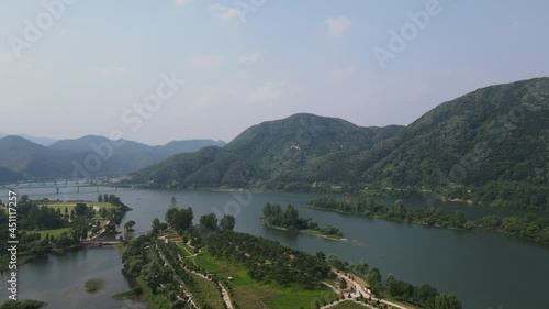 Beautiful aerial shot flying in rural South Korea with mountains and river photo