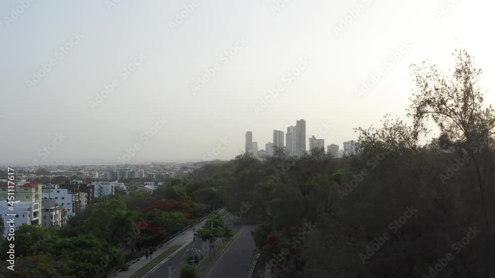 Drone flying over pedestrian and cycle path at Mirador Sur Park with skyscrapers in background, Santo Domingo Drone flying over pedestrian and cycle path at Mirador Sur Park with skyscrapers in background, Santo Domingo