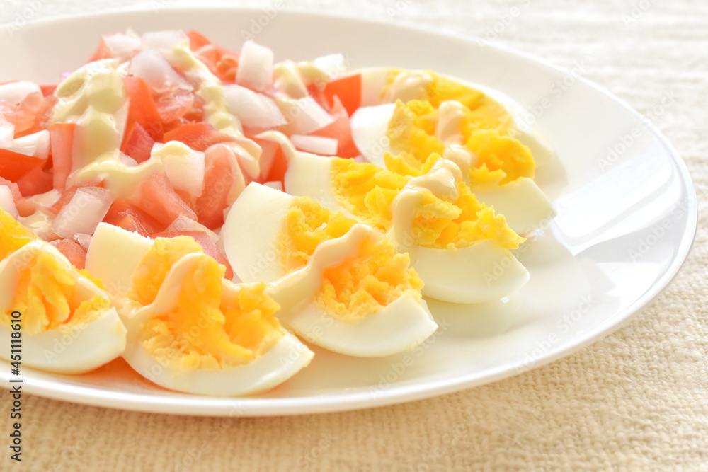 Boiled egg salad with tomatoes and onions on a white plate. The concept of healthy and dietary food.
Boiled egg salad with tomatoes and onions on a white plate. The concept of healthy and dietary food.