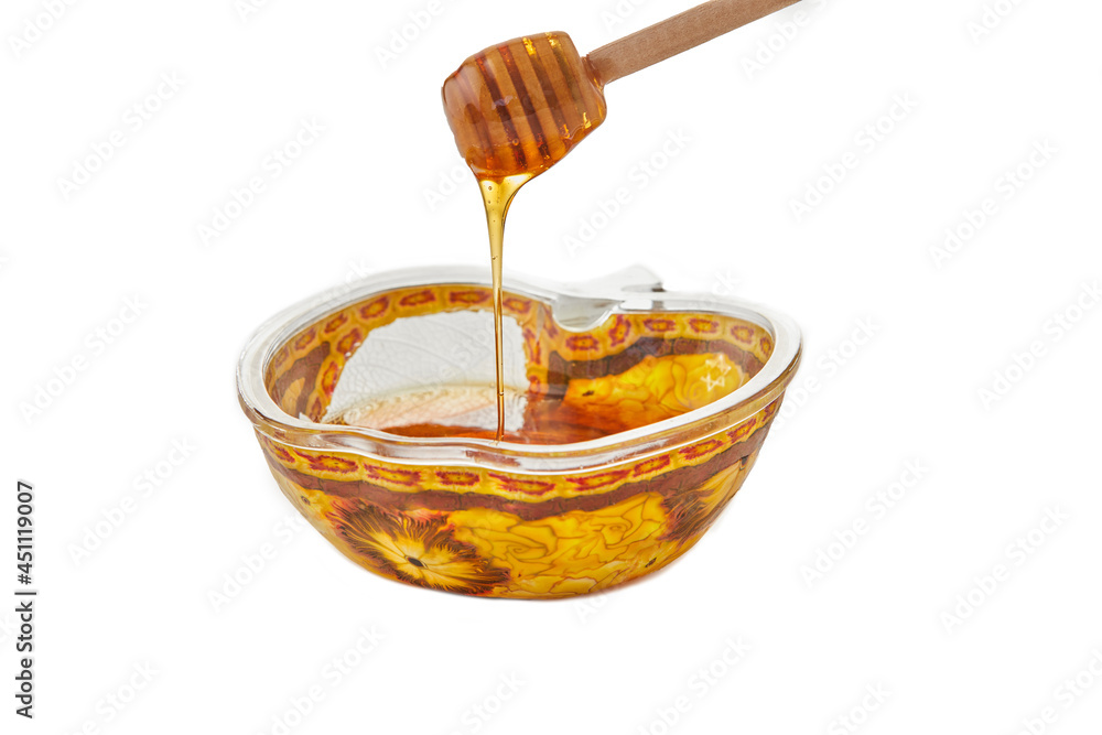 Rosh Hashanah is concept for the Jewish New Year holiday. An apple-shaped bowl with honey and stick on white background Rosh Hashanah is concept for the Jewish New Year holiday. An apple-shaped bowl with honey and stick on white background