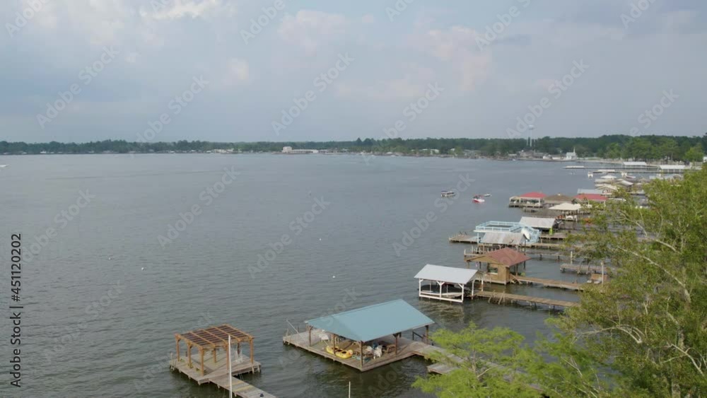 Drone shot passing lake docks on a cloudy day Drone shot passing lake docks on a cloudy day