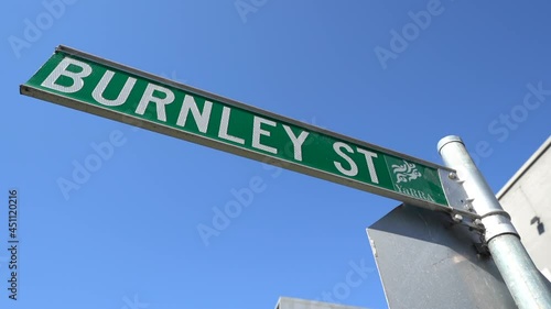 Signpost plate of Burnley street on pole in Melbourne, close up orbit view photo
