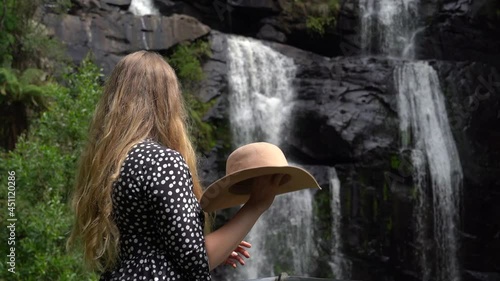 Beautiful caucasian blonde hair woman enjoy view of Steavenson falls, boom up view photo