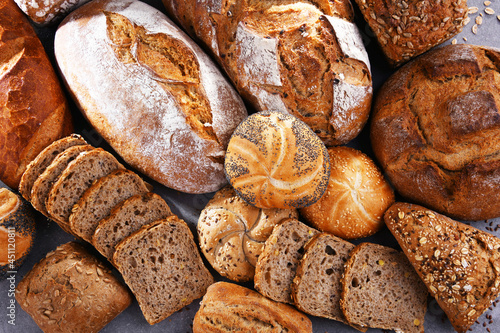 Assorted bakery products including loafs of bread and rolls photo