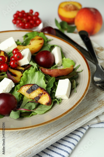 Concept of tasty salad with grilled peach, close up