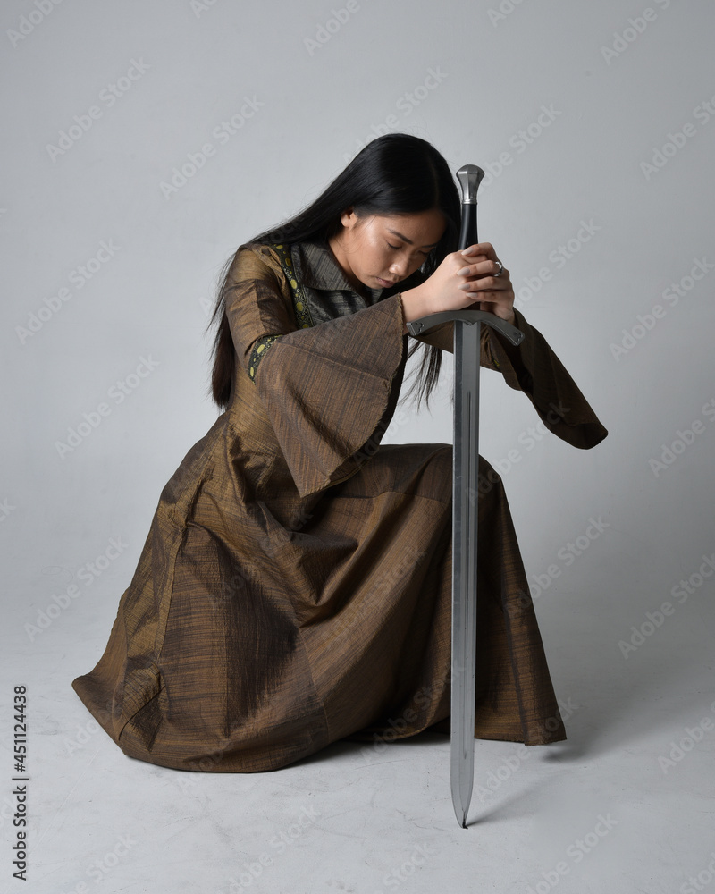 Woman with sword in white fluttering dress. Stock Photo by ©fxquadro  88540628
