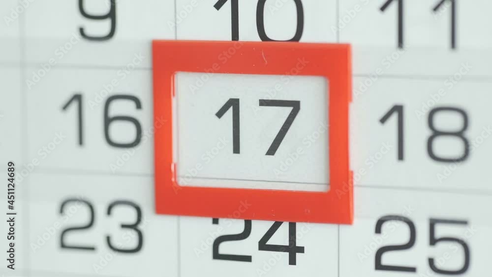 Close-up of a woman's finger moves the date pointer on the calendar Close-up of a woman's finger moves the date pointer on the calendar