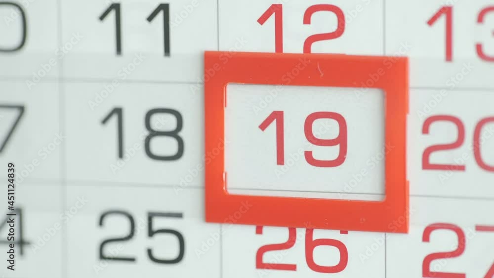 Close-up of a woman's finger moves the date pointer on the calendar Close-up of a woman's finger moves the date pointer on the calendar
