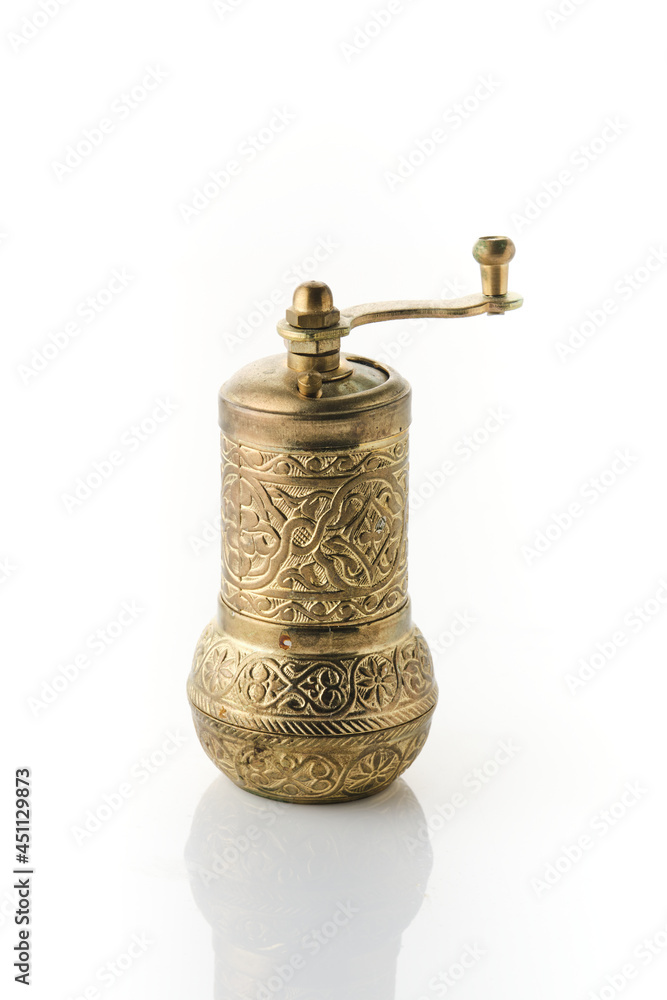 Old brass spice grinder isolated on white. Old brass spice grinder isolated on white.