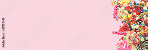 Colorful candies on pink background