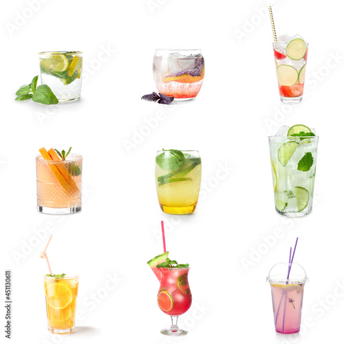 Glasses of tasty cold lemonade with basil on white background