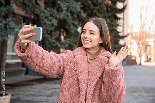 Beautiful young woman takin...