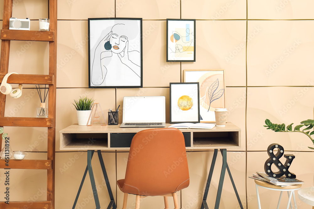 Fototapeta premium Interior of stylish room with modern workplace and pictures