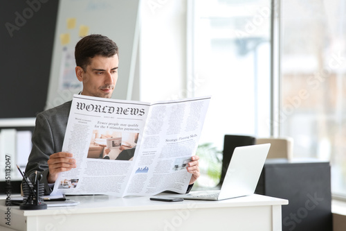 Young businessman reading n...