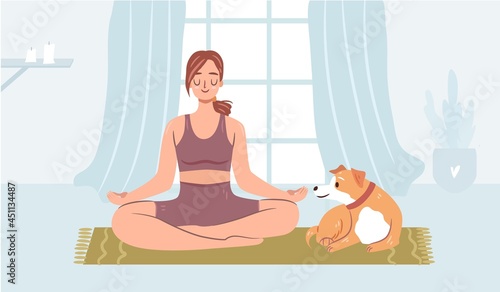 Girl doing yoga with a dog on a mat. Happy woman meditating at home. Cozy atmosphere. Funny dog in a collar