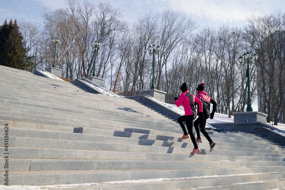 fit people running on stairs in park