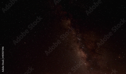 The cosmic landscape was captured in the Milky Way galaxy with stars on the night sky background. The Milky Way is the galaxy that contains our solar system.