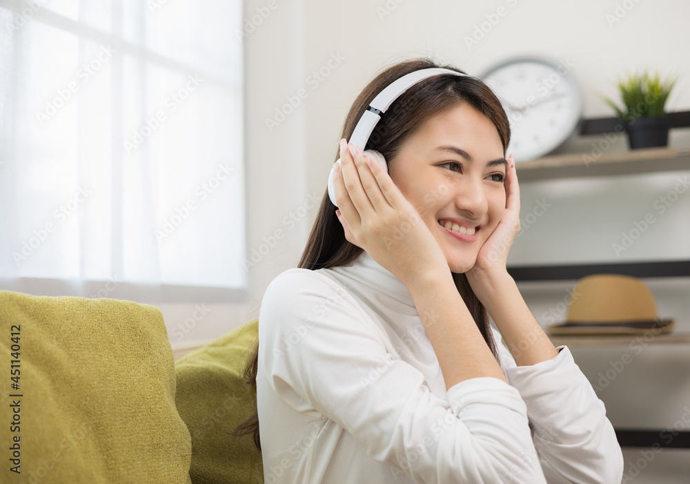 Relaxing time on sofa. Beautiful young asian woman lay down on sofa and listening to the music with headphone. She has rhythm Lifestyle in living room at house in the morning. Relaxing time on sofa. Beautiful young asian woman lay down on sofa and listening to the music with headphone. She has rhythm Lifestyle in living room at house in the morning.