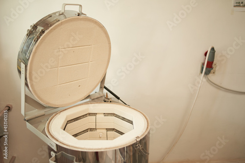 Canvas Print Electric kiln near wall in pottery