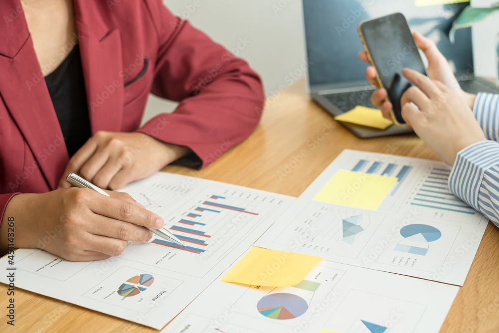 Two business leaders talk about charts, financial graphs showing results are analyzing and calculating planning strategies, business success building processes Two business leaders talk about charts, financial graphs showing results are analyzing and calculating planning strategies, business success building processes