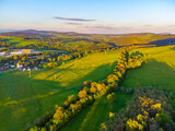 Green rural landscape of Northern Bohemia at susnet time. Aerial view from drone.