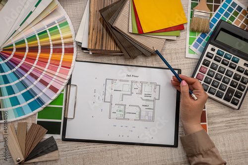 hand selects a color from the palette on architectural plan