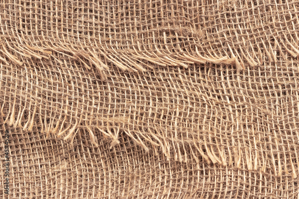 Natural burlap with large cells. The texture of a coarse woven fabric with mesh and fibers. Natural burlap with large cells. The texture of a coarse woven fabric with mesh and fibers.