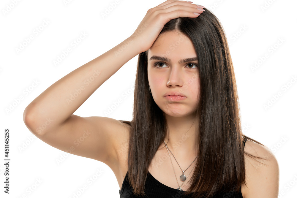 Young frustrated girl holding her head with her hand