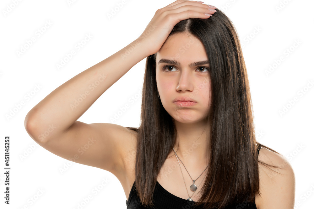 Young frustrated girl holding her head with her hand Young frustrated girl holding her head with her hand