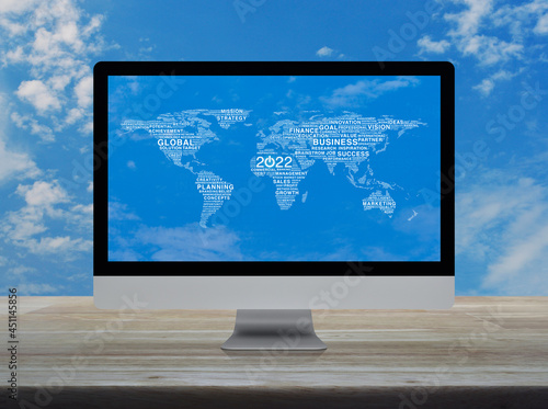 Start up business icon with global words world map on desktop modern computer monitor screen on wooden table over blue sky, Happy new year 2022 global business start up online concept, Elements of thi