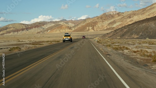 Road trip to Death Valley, Artists Palette drive, California USA. Hitchhiking auto traveling in America. Highway, colorful bare mountains and arid climate wilderness. View from car. Journey to Nevada. © Dogora Sun